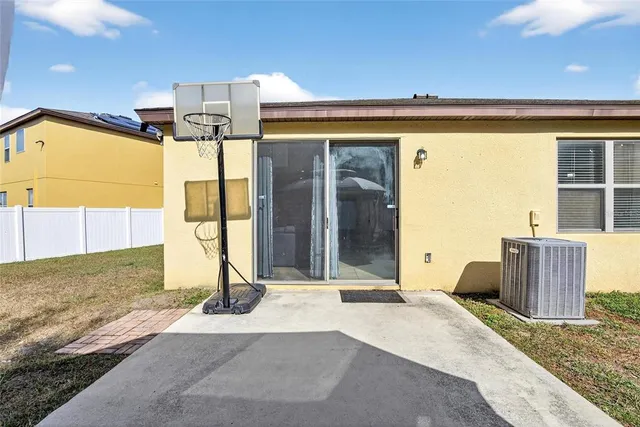 a view of a bedroom with a bed and wooden floor