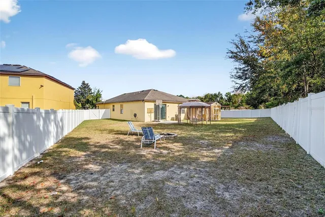 a view of a house with backyard of the house