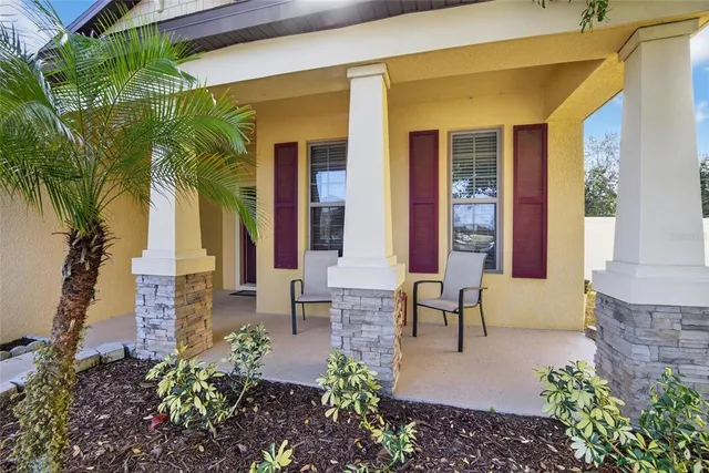 a view of a hallway with wooden floor and windows