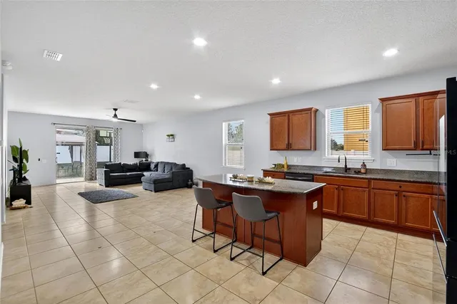 a kitchen with sink and living room