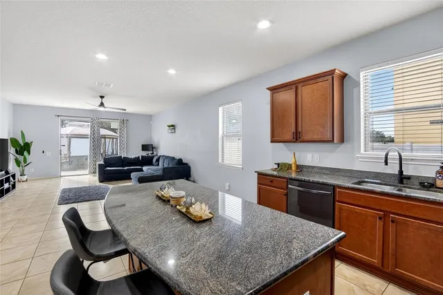 a kitchen with stainless steel appliances granite countertop a stove top oven a sink a counter top space and cabinets