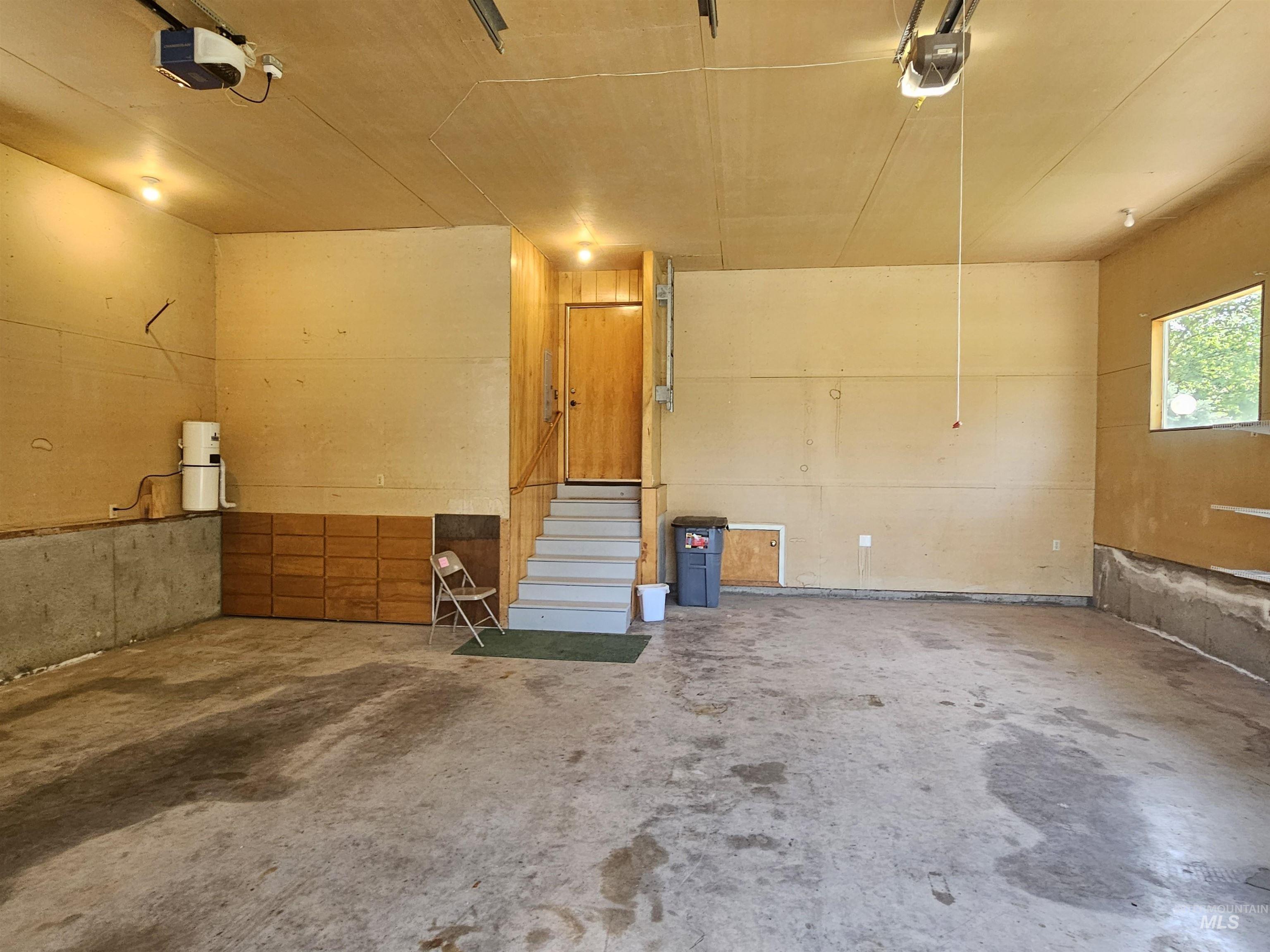 29865 Mission Creek Road Culdesac, ID 83524 - Photo 35 of 43 Spacious garage featuring a concrete floor, overhead lighting, and two garage door openers