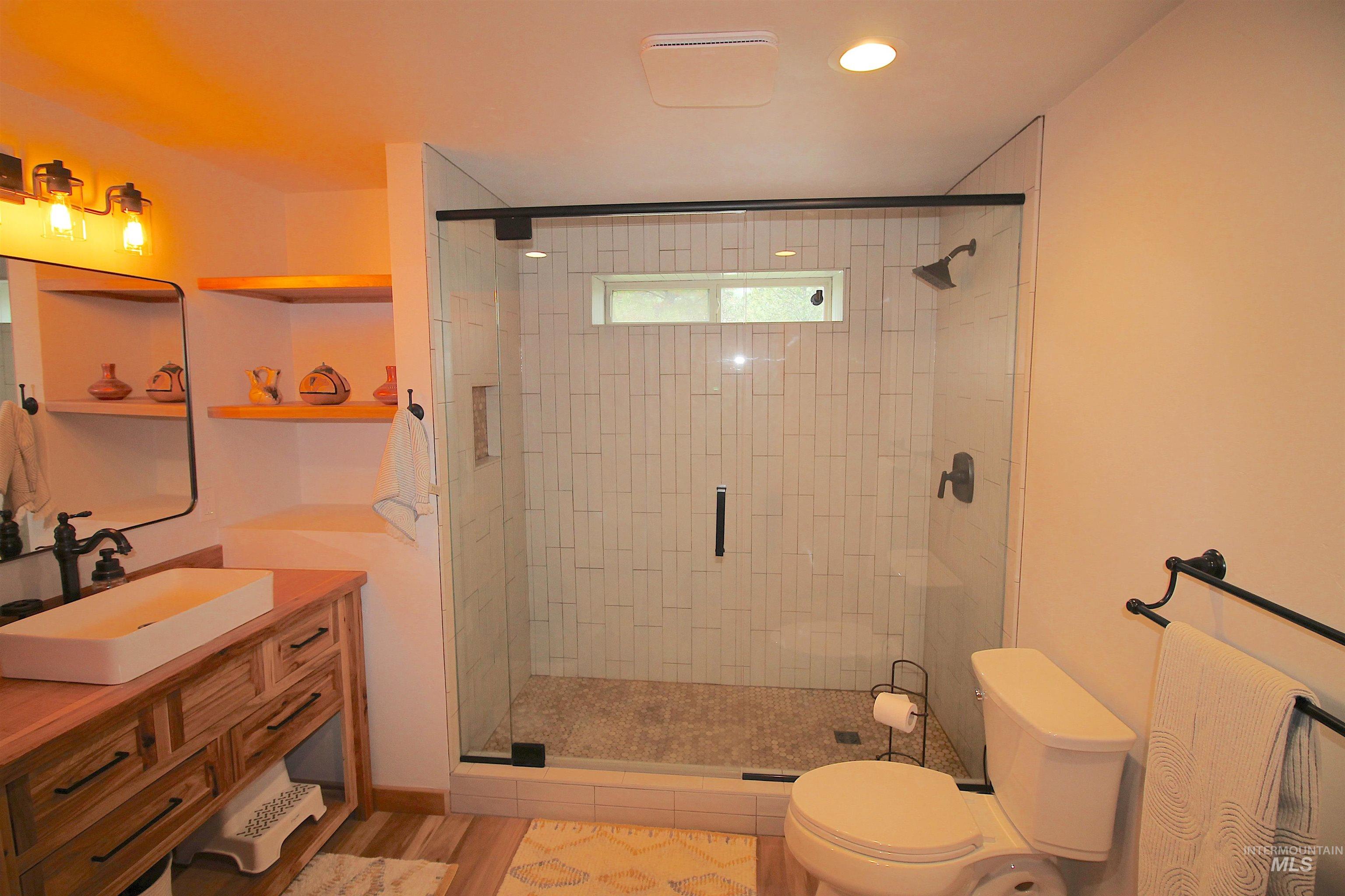2609 Highway 95 Council, ID 83612 - Photo 19 of 49 Full bath with vanity, a shower stall, and light wood finished floors