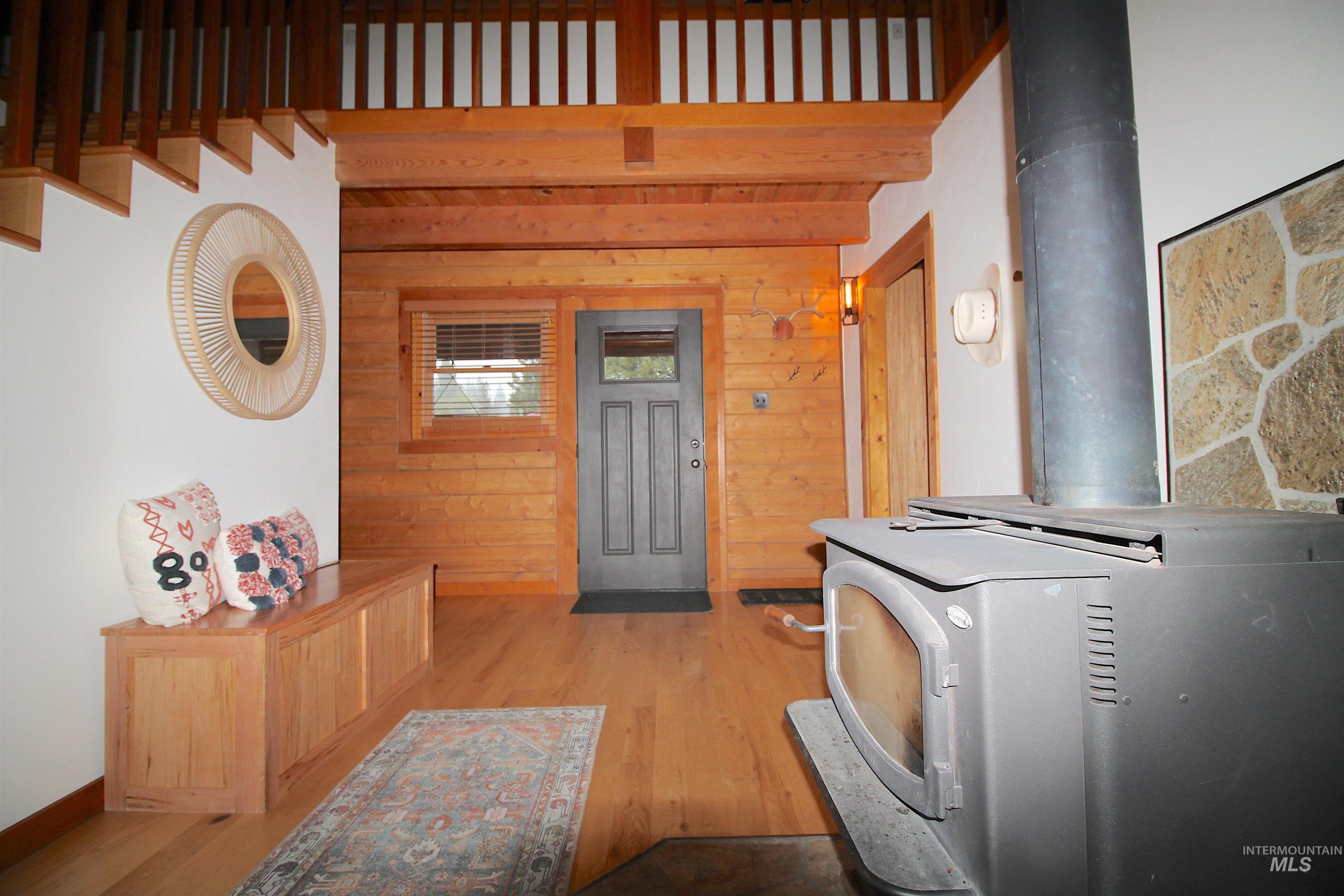 2609 Highway 95 Council, ID 83612 - Photo 20 of 49 Kitchen with a wood stove, wooden walls, light wood-style floors, and heating unit