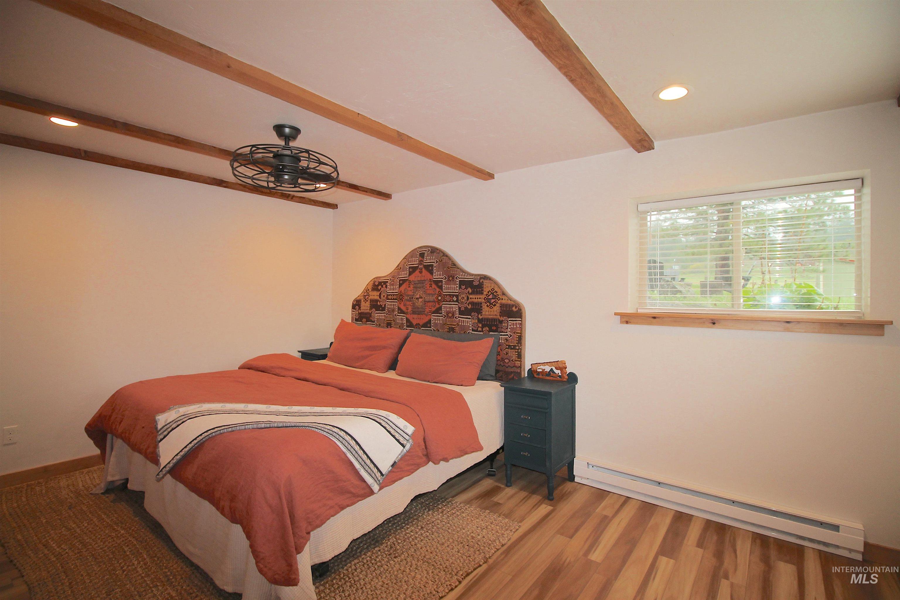 2609 Highway 95 Council, ID 83612 - Photo 25 of 49 Bedroom featuring a baseboard radiator, wood finished floors, recessed lighting, and beamed ceiling