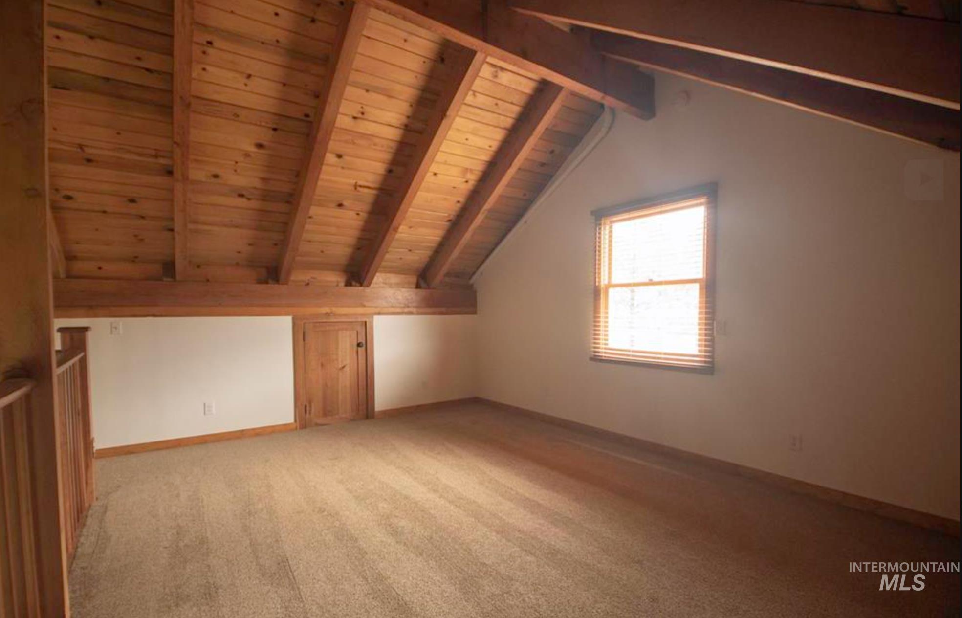 2609 Highway 95 Council, ID 83612 - Photo 26 of 49 Additional living space with a wooden ceiling with exposed beams and light colored carpet