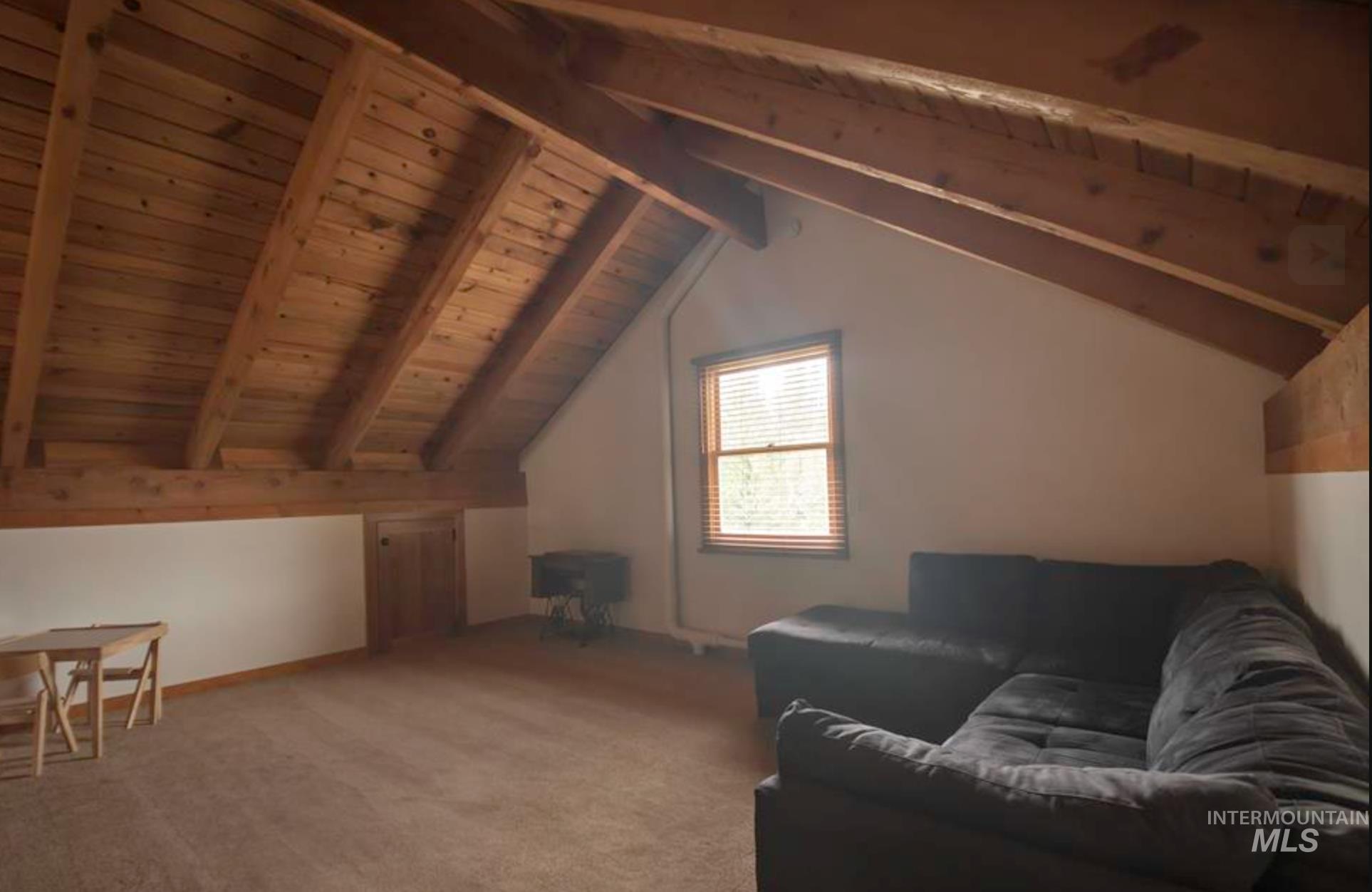2609 Highway 95 Council, ID 83612 - Photo 28 of 49 Living area featuring a wooden ceiling with exposed beams and carpet flooring