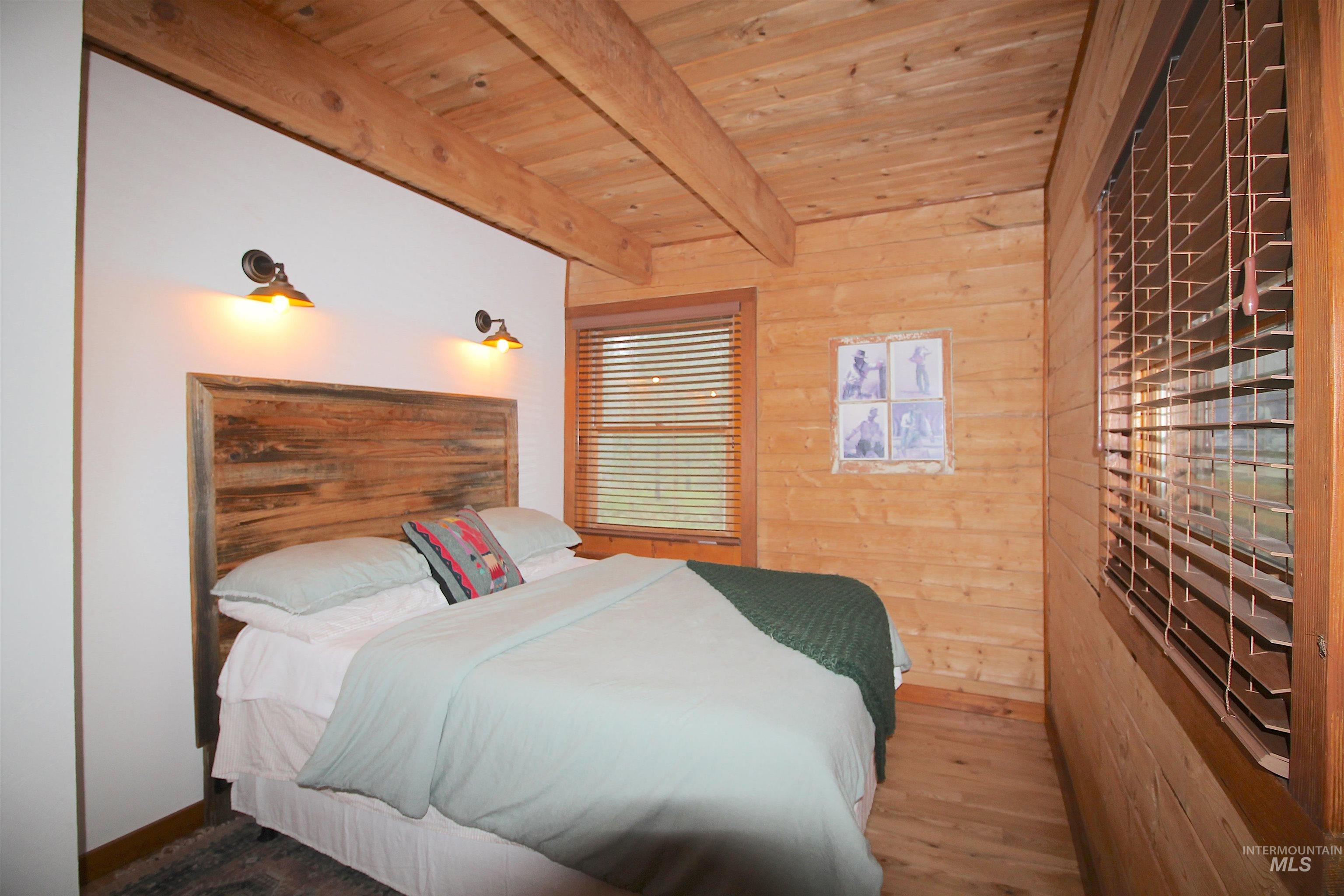 2609 Highway 95 Council, ID 83612 - Photo 34 of 49 Bedroom featuring wood walls, wood finished floors, and a wooden ceiling with exposed beams