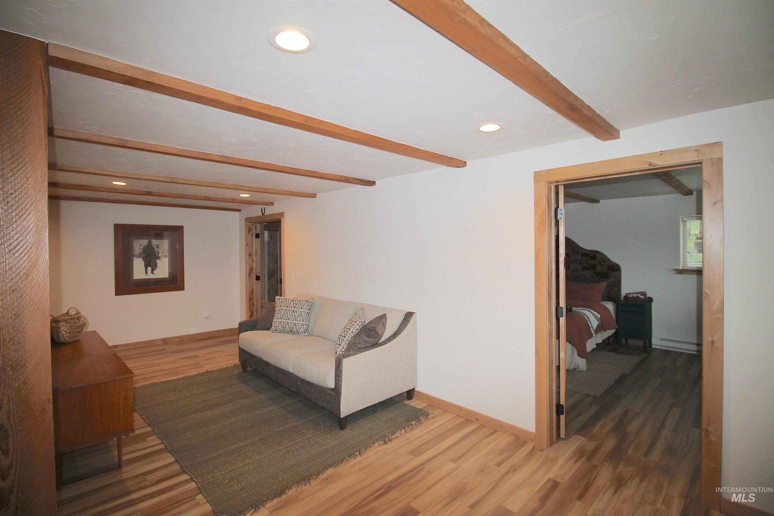 2609 Highway 95 Council, ID 83612 - Photo 36 of 49 Sitting room featuring beamed ceiling, light wood-style flooring, recessed lighting, and baseboard heating