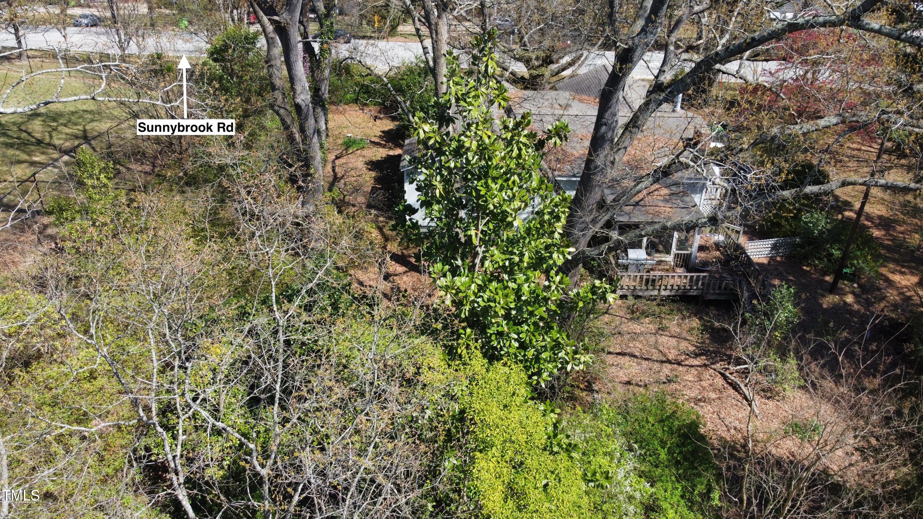 620 Sunnybrook Road Raleigh, NC 27610 - Photo 5 of 10 a view of a house with a lush green forest