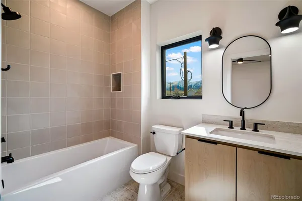 a bathroom with a toilet sink and a bathtub