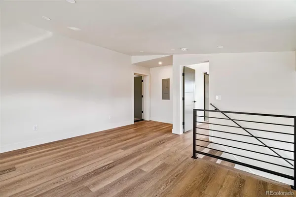 a view of a room with wooden floor