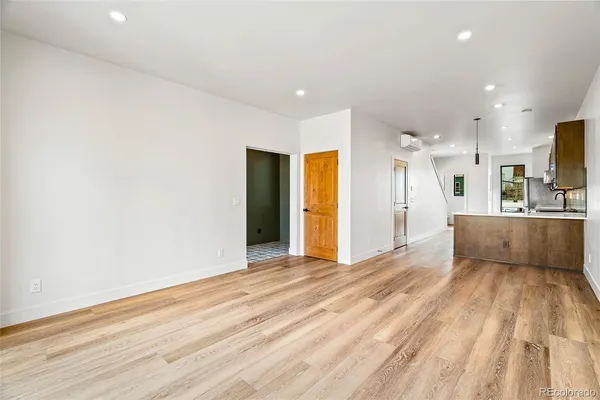 a large kitchen with stainless steel appliances granite countertop a refrigerator a sink and a stove