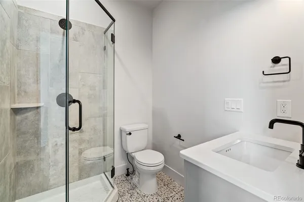 a bathroom with a granite countertop sink double vanity granite and a mirror