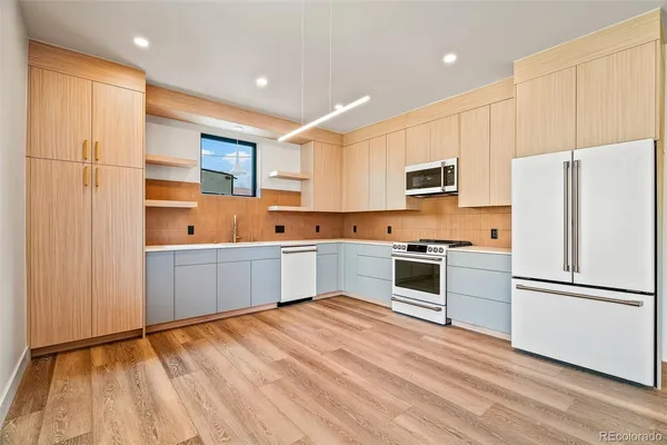a kitchen with stainless steel appliances a refrigerator and a stove top oven