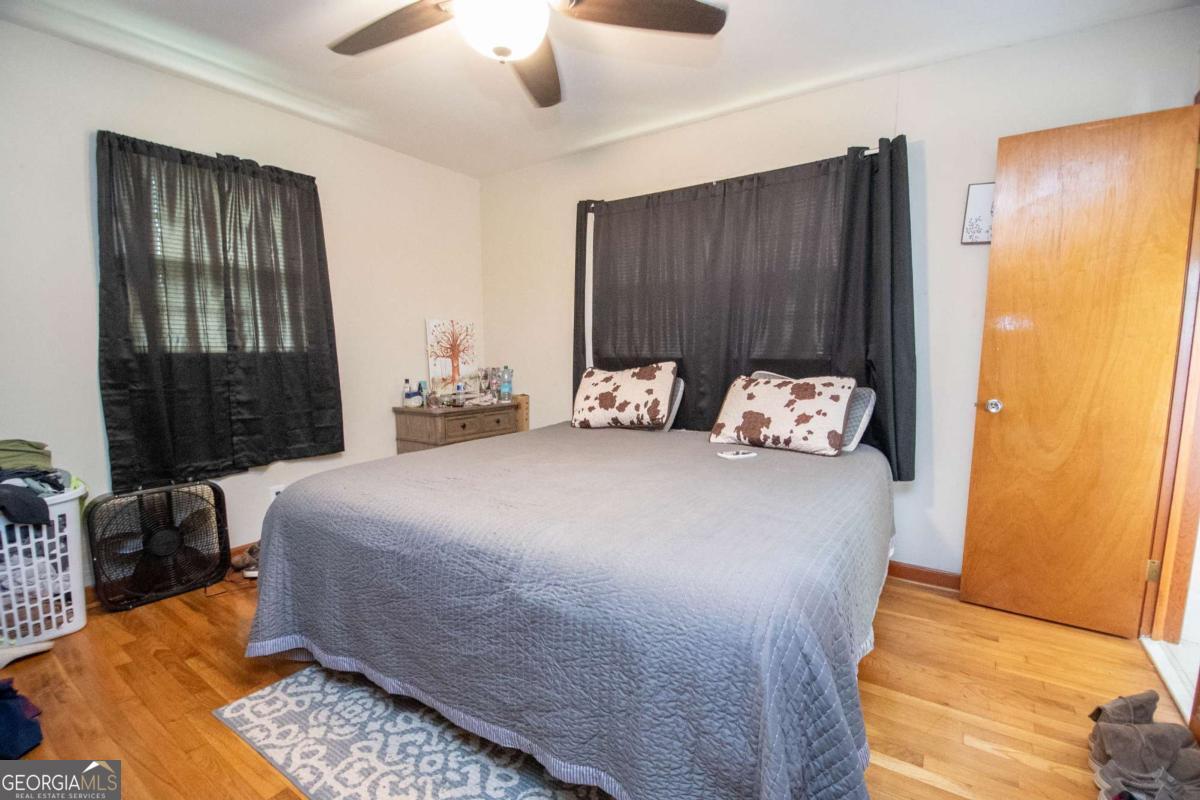 313 Mobley Street Griffin, GA 30223 - Photo 11 of 22 a bedroom with a bed and wooden floor