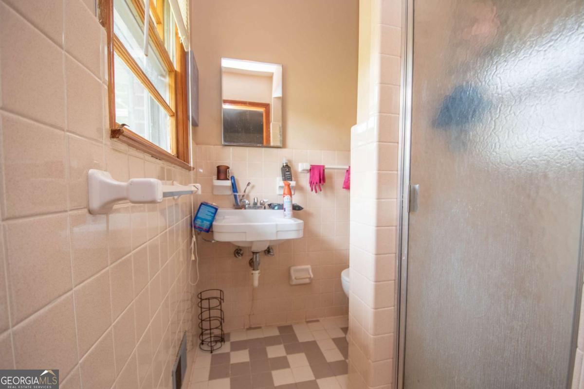 313 Mobley Street Griffin, GA 30223 - Photo 12 of 22 a bathroom with a sink and a mirror