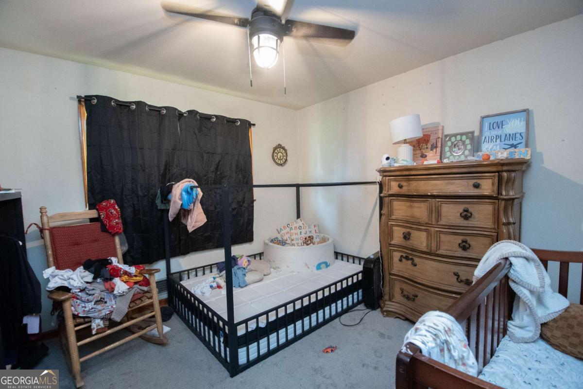 313 Mobley Street Griffin, GA 30223 - Photo 13 of 22 a bedroom with a bed and wooden floor