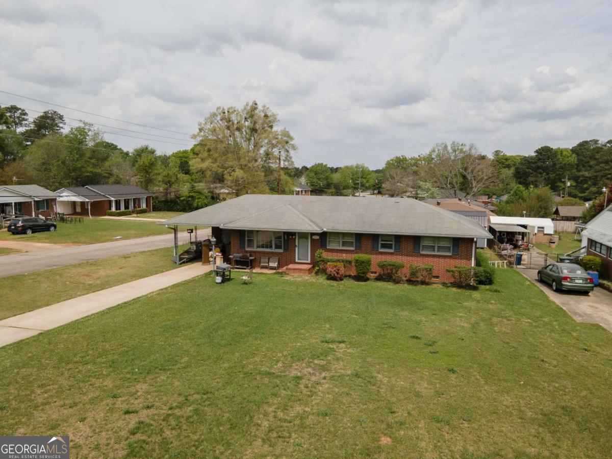 313 Mobley Street Griffin, GA 30223 - Photo 3 of 22 a view of a house with garden and a car parked