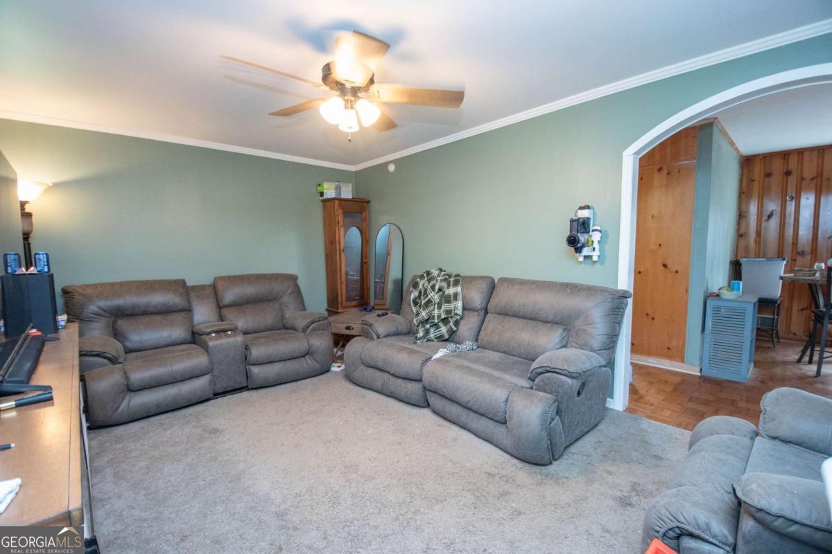 313 Mobley Street Griffin, GA 30223 - Photo 5 of 22 a living room with furniture and a chandelier