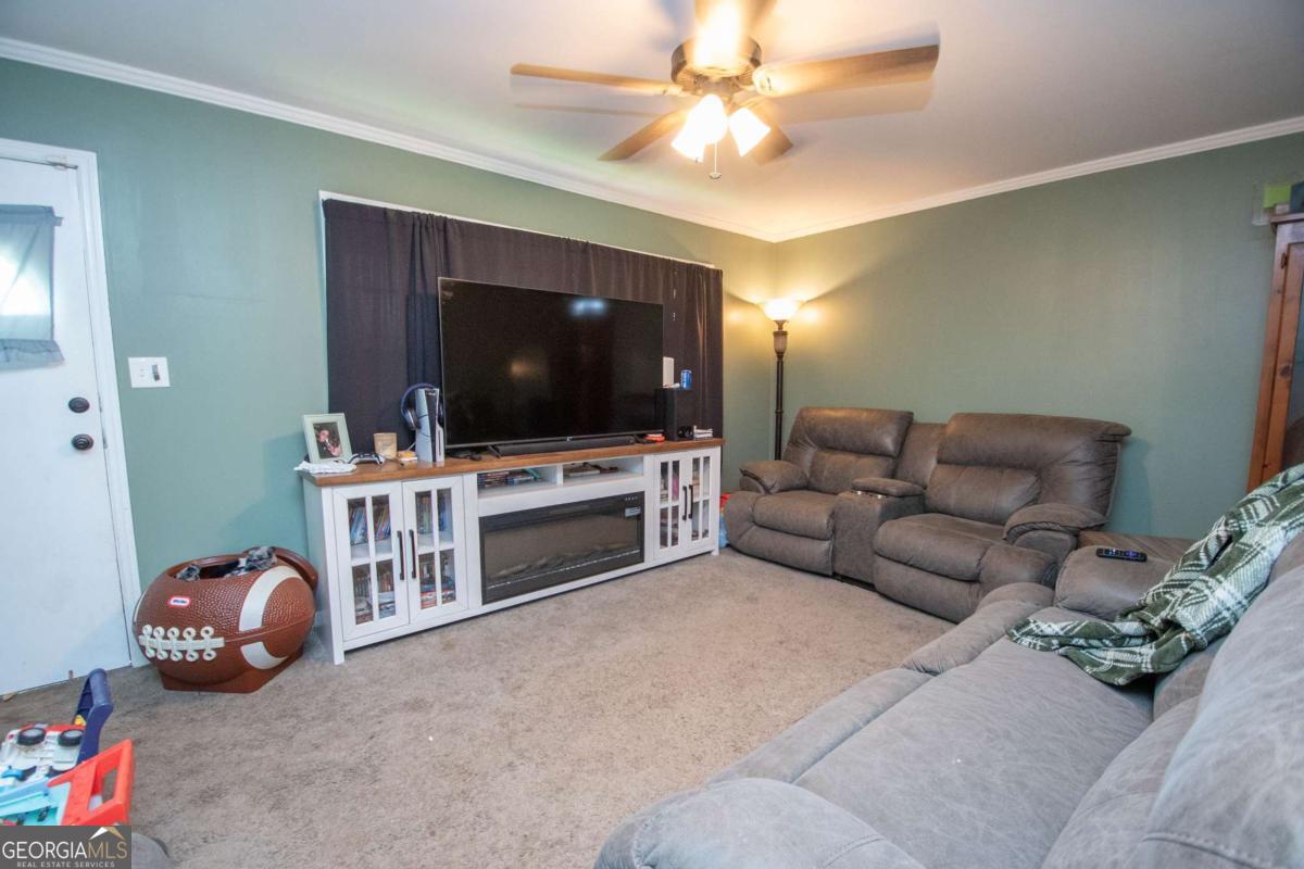 313 Mobley Street Griffin, GA 30223 - Photo 6 of 22 a living room with furniture and a flat screen tv