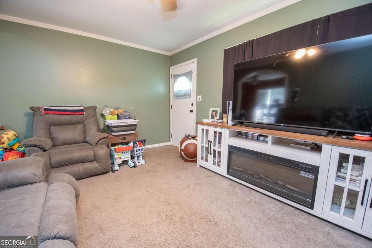 313 Mobley Street Griffin, GA 30223 - Photo 8 of 22 a living room with furniture and a flat screen tv