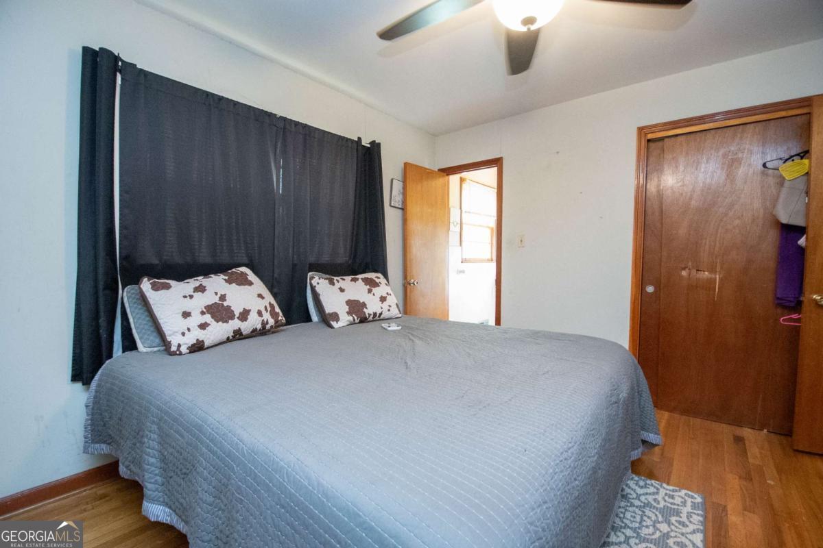 313 Mobley Street Griffin, GA 30223 - Photo 10 of 22 a large bedroom with bed and a chandelier