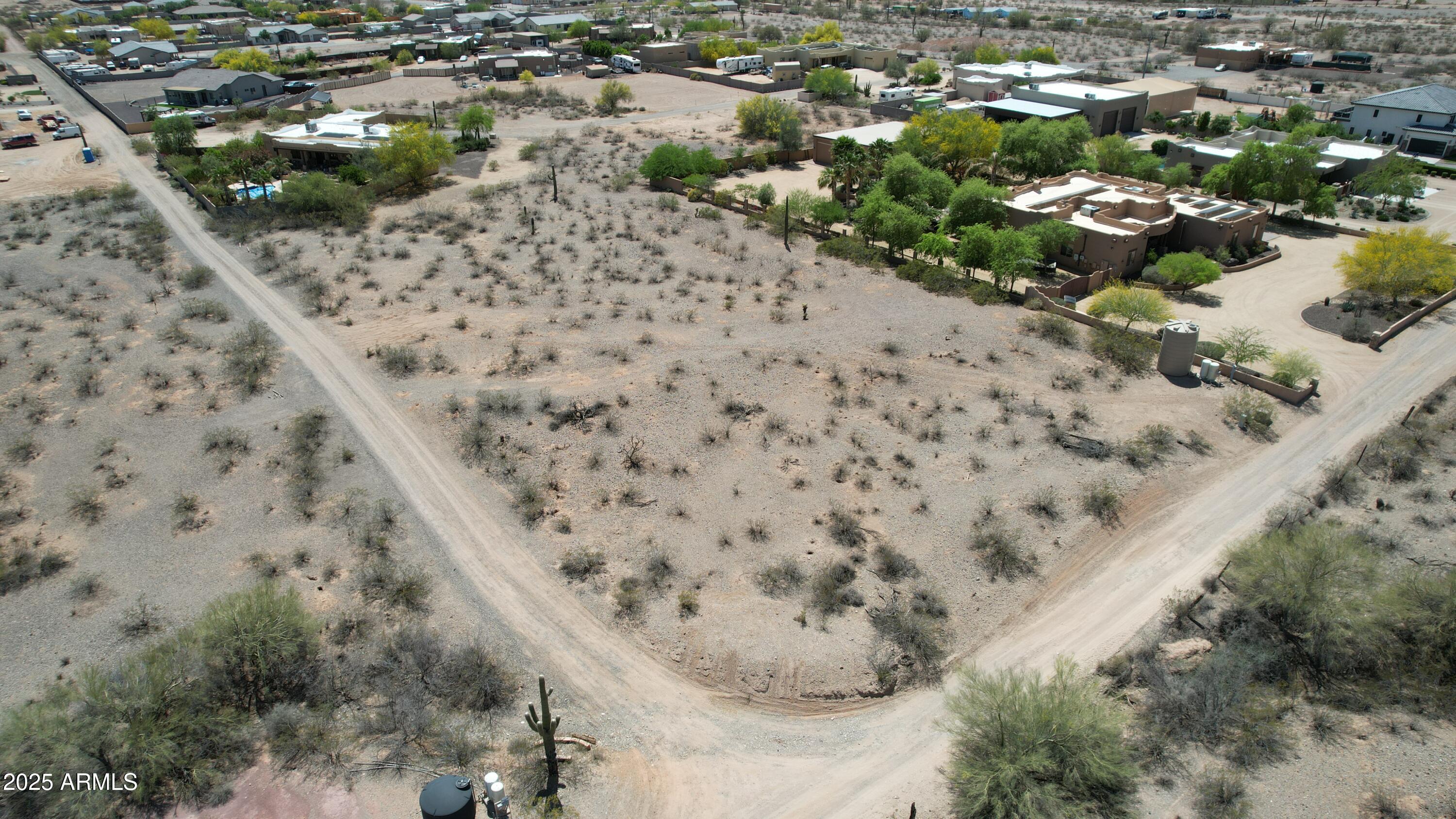 a view of a dry yard with a mountain