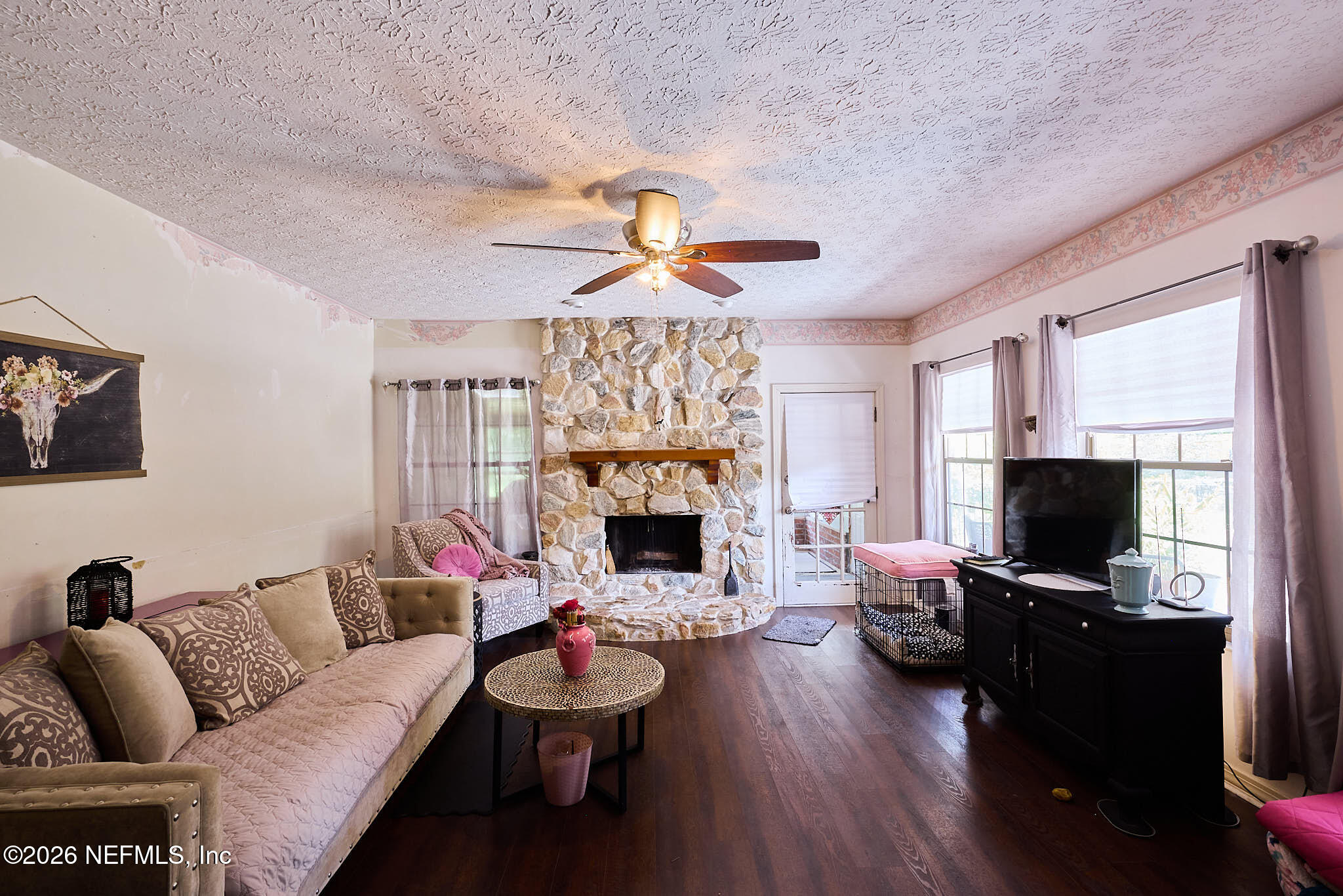 8965 San Rae Road Jacksonville, FL 32257 - Photo 22 of 46 a living room with furniture a fireplace and a flat screen tv