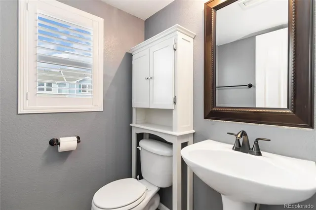 a bathroom with a sink toilet and mirror