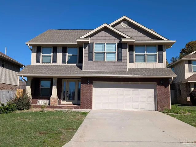 a front view of a house with a garden and porch