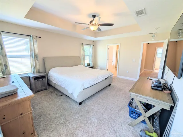 a bedroom with a bed and a desk