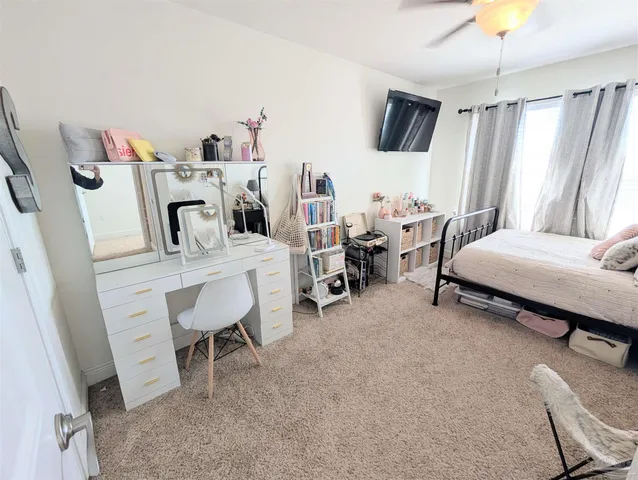 a bedroom with a bed a desk and chair