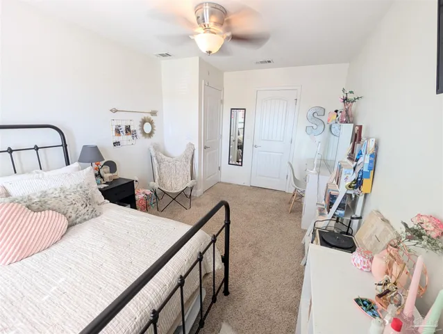 a bedroom with two beds and a chandelier