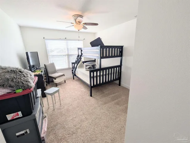 a bedroom with furniture and a window