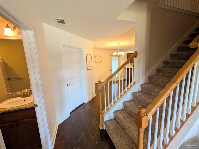 a view of entryway and hall with wooden floor
