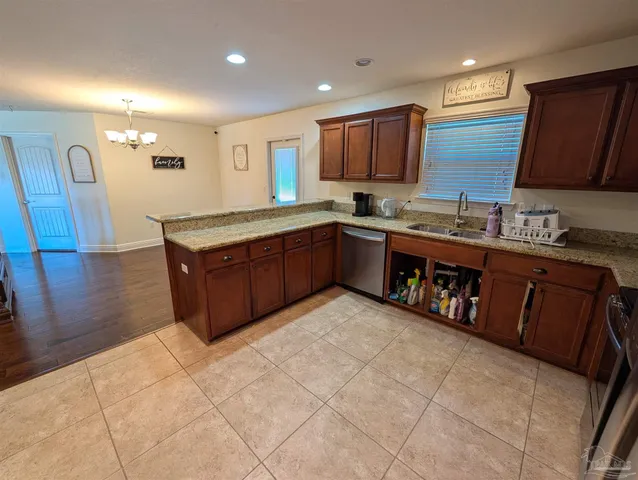 a kitchen with stainless steel appliances granite countertop a sink counter space cabinets and a large window