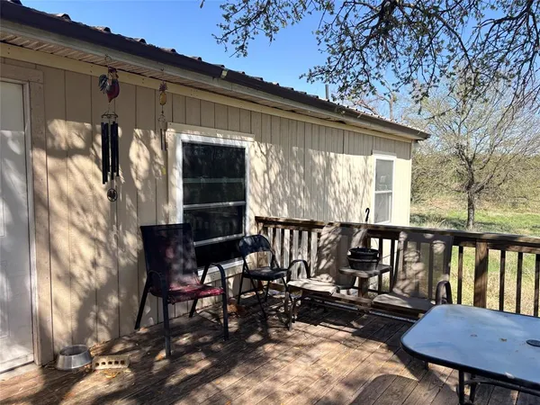 a view of a chairs and table in patio