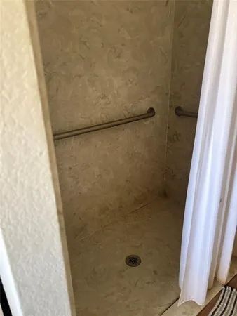 a bathroom with a glass shower door