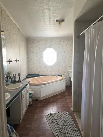 a spacious bathroom with a granite countertop sink and a mirror