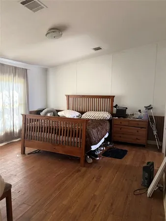 a bedroom with a bed and a window