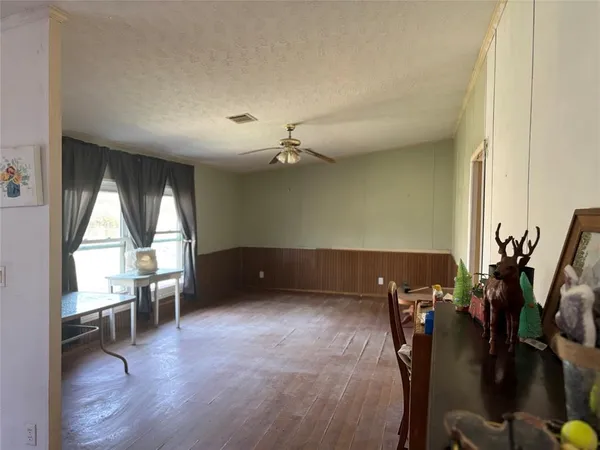 a view of a livingroom with furniture window and wooden floor