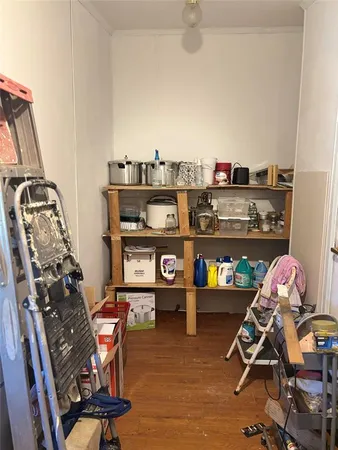 a room with wooden floor and white walls