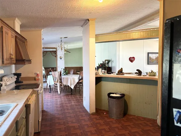 a kitchen with a refrigerator and cabinets