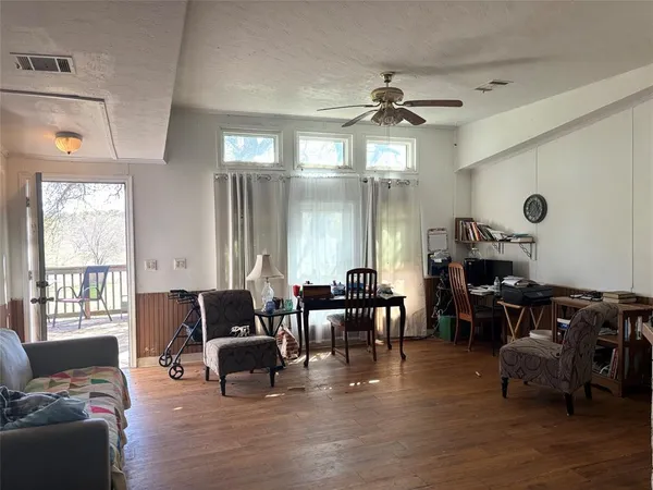 a view of a dining room with furniture and wooden floor
