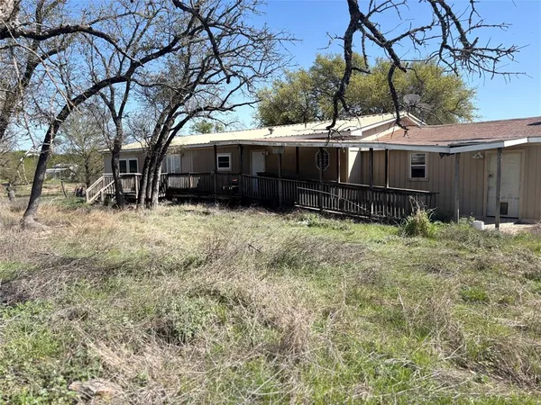 a view of a house with a yard covered with snow in the yard