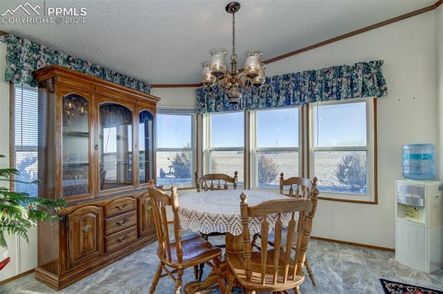 34170 Big Springs Road Yoder, CO 80864 - Photo 9 of 35 Dining Room-Additional Windows behind hutch. *Hanging Chandelier is excluded