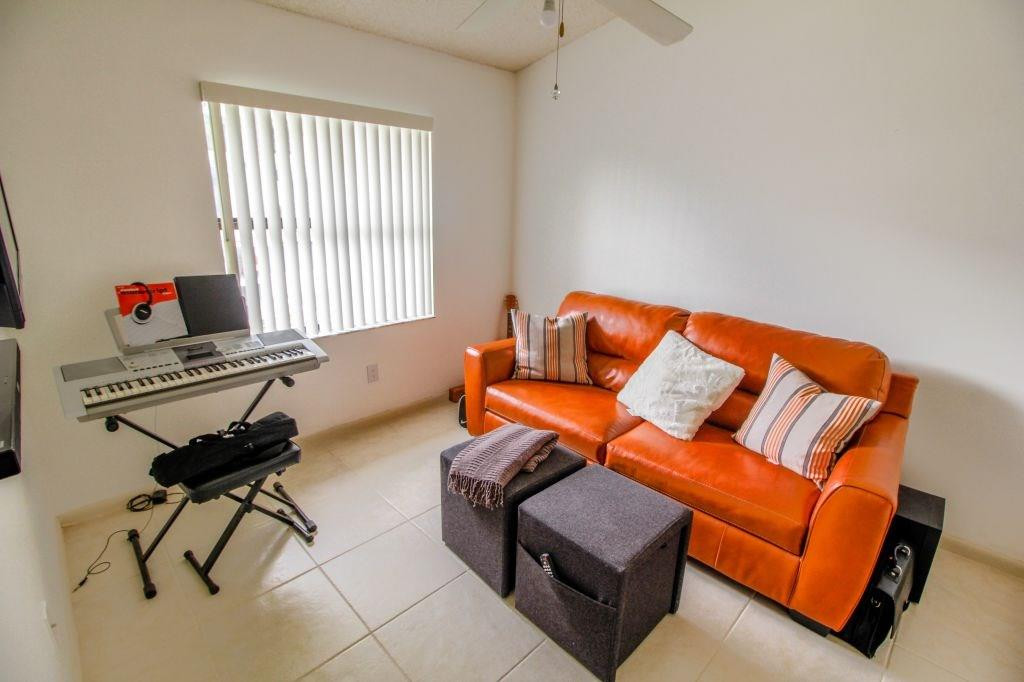 9095 Southwest 21st Court, Unit E Boca Raton, FL 33428 - Photo 10 of 22 a living room with furniture and a window