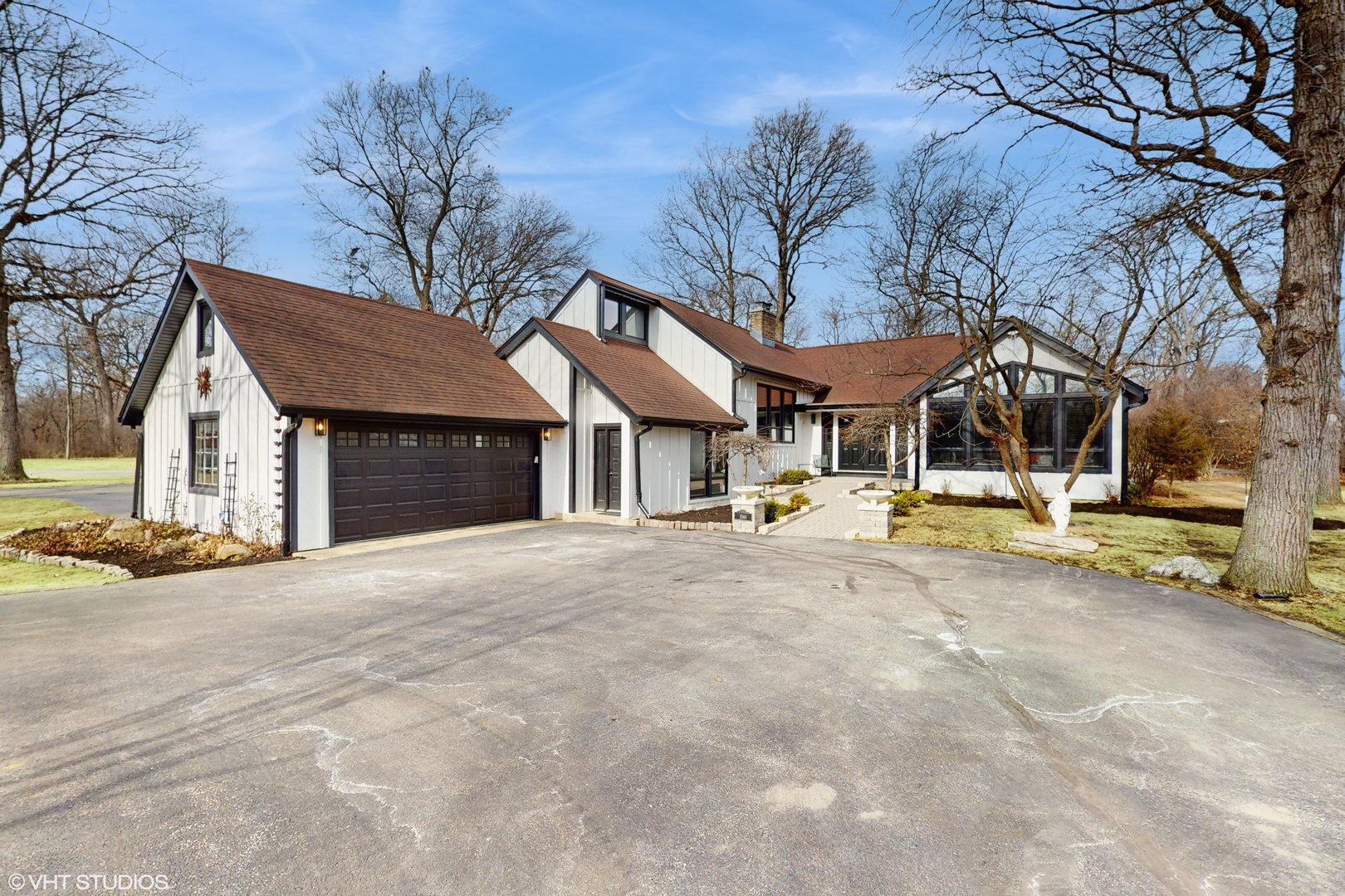 a view of a house with large trees and a big yard