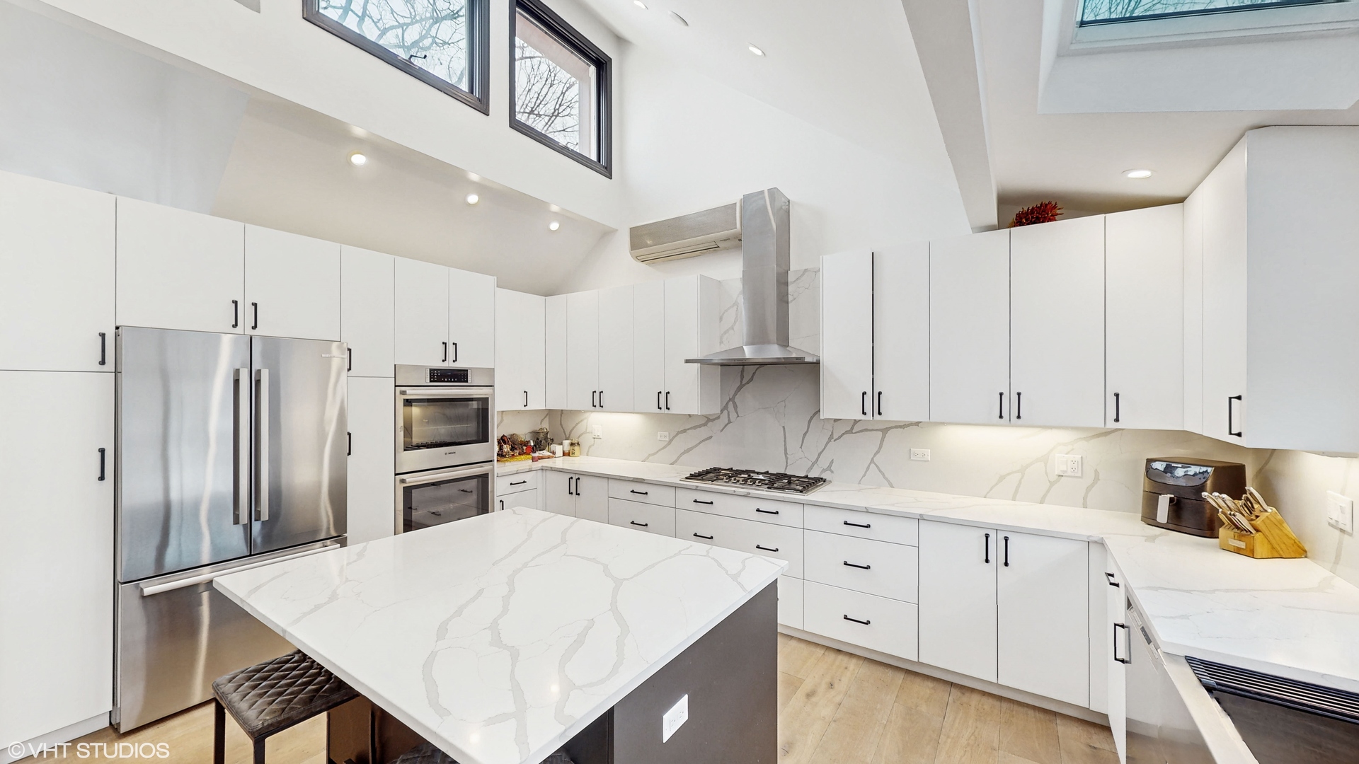 15160 West Oak Spring Road Libertyville, IL 60048 - Photo 11 of 36 a kitchen with white cabinets and stainless steel appliances